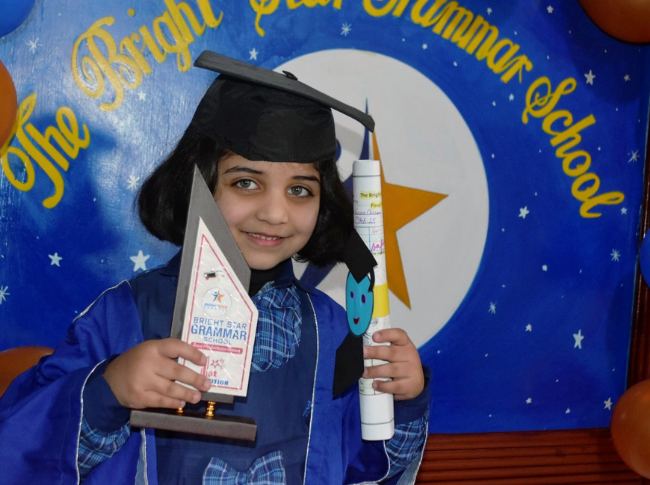 A young graduate with her award