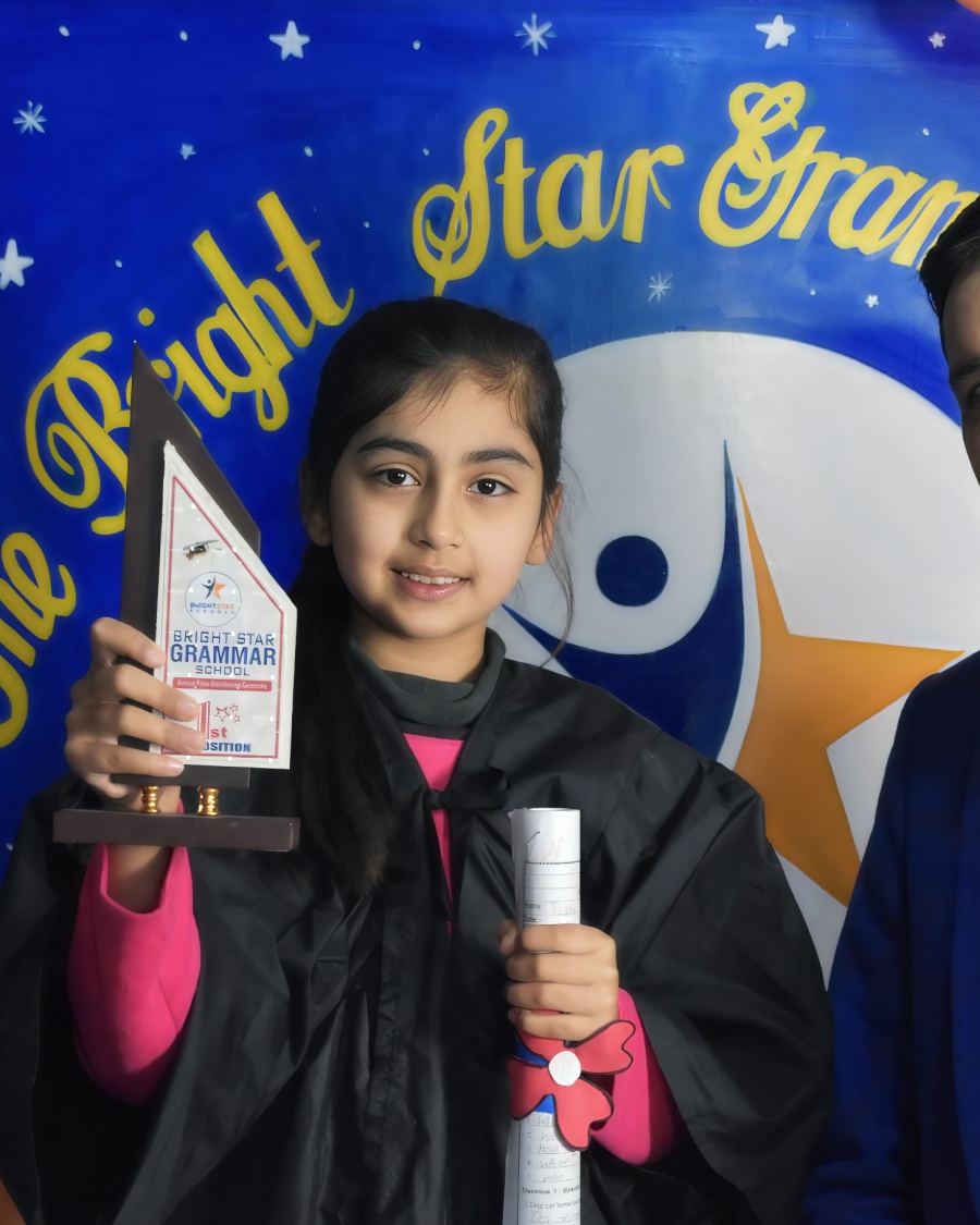 A young graduate with her award